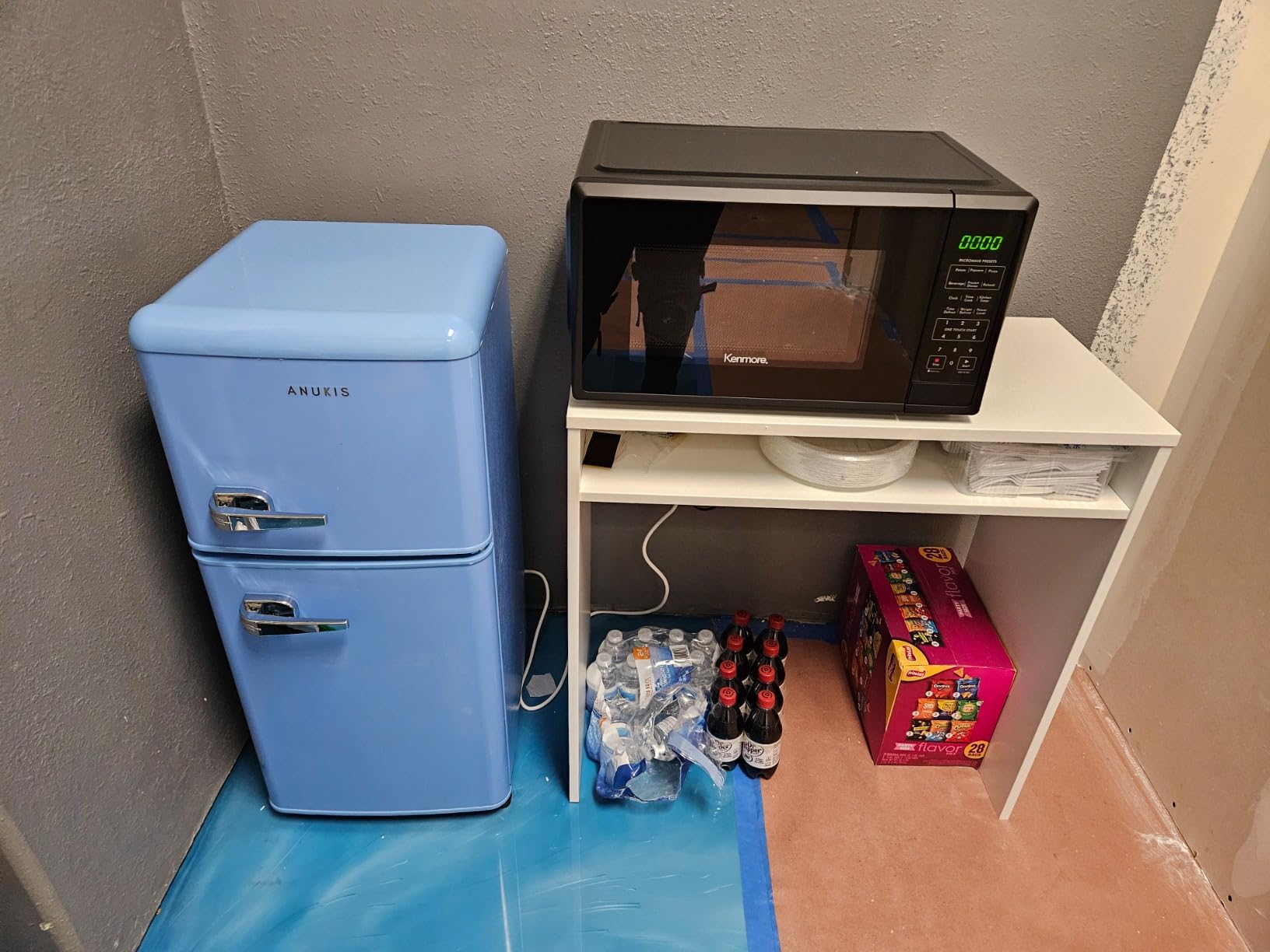 Anukis customer photo — fridge in a garage with stocked drinks
